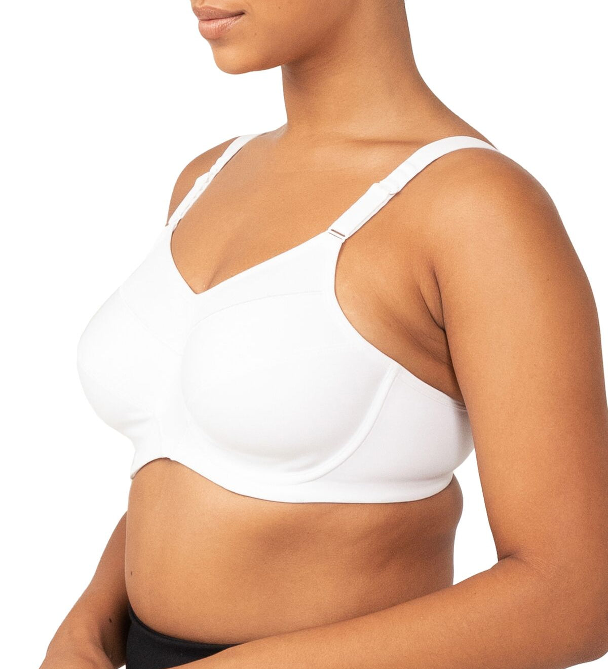 Side profile of a model wearing the Triaction Ultra W Sports Bra White, highlighting underwired support.