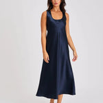 Model wearing navy blue silk long nightie with wide straps and flattering scoop neckline.