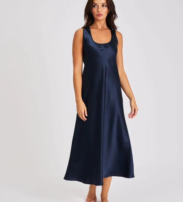 Model wearing navy blue silk long nightie with wide straps and flattering scoop neckline.