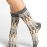 Woman wearing Bleuforet Wool Cashmere Multi Check Socks in Gris, featuring a colourful multicoloured check pattern and ribbed cuff, available at The Foundation.
