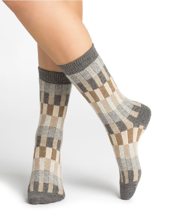 Woman wearing Bleuforet Wool Cashmere Multi Check Socks in Gris, featuring a colourful multicoloured check pattern and ribbed cuff, available at The Foundation.