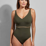 Front view of Model showcasing full fit of the Cosmic V-Neck swimsuit in earthy Lichen, with smooth shaping and elegant silhouette.