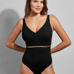 Model wearing the Empreinte Cosmic V-Neck One Piece swimsuit in black, featuring gold detail and a flattering fit.