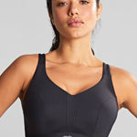 front view of Model wearing the Endurance Wired Sports Bra in Black highlighting the sporty cut and fit.
