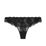 Flat lay of Reve Tanga Thong Brief Black from The Foundation – delicate black lace with cotton gusset for breathable wear.