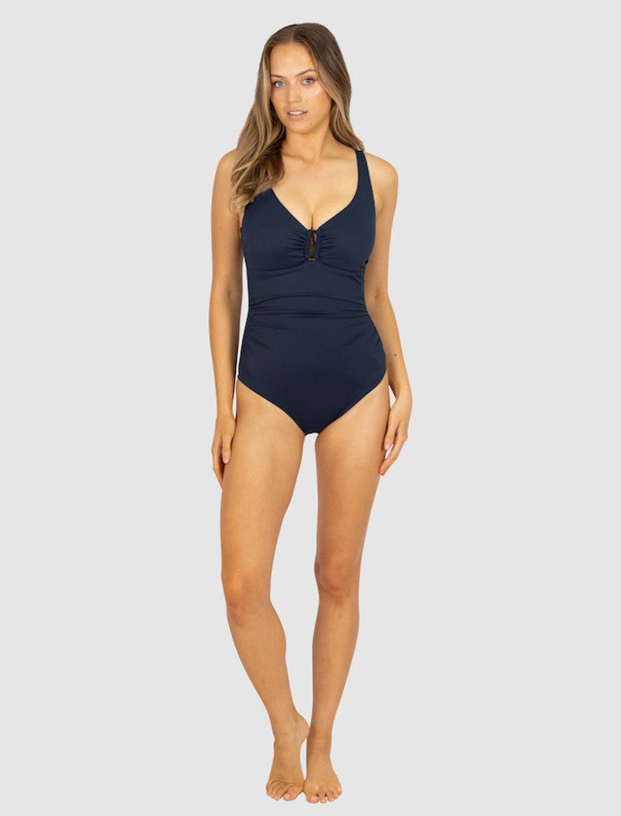 Model wearing Baku Rococco Ring Front Swimsuit in deep navy Nightfall shade, with shaping panels and elegant design, found at The Foundation.