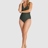 Model in full-length Baku Rococco E–F One Piece Swimsuit, olive green with convertible straps and flattering structure, from The Foundation.