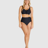 Model wearing Baku Rococco EFG Cup Bra Nero, a black supportive bra with lace details, wide straps, and full coverage fit, available at The Foundation.