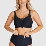 Front-facing image of model adjusting Baku Rococco EFG Cup Bra Nero, showing lace-up details and underwire support.