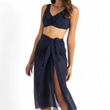 Model wearing Cosmopolitan Classic Mesh Sarong Ink by Jantzen, available at The Foundation, styled as a lightweight midi wrap over swimwear.