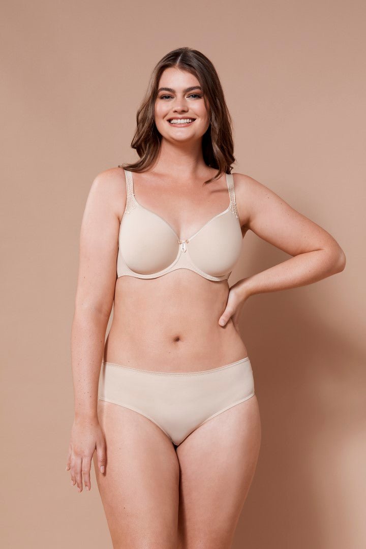 Smiling model in Virginia Spacer Bra in Skin tone from The Foundation, featuring smooth cups, breathable spacer fabric, and a supportive fit.
