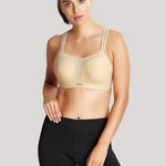 Lifestyle shot of The Foundation’s Panache Sports Bra in Latte styled with activewear for a sporty-chic look.