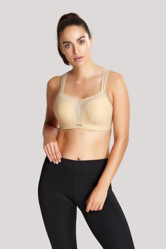 Lifestyle shot of The Foundation’s Panache Sports Bra in Latte styled with activewear for a sporty-chic look.