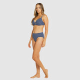 Side view of Model walking in Baku Castaway Navy bikini showcasing high-waisted bottom and bralette top.
