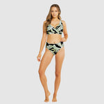Front view of Model showcasing tummy control swim brief in tropical black and white print with matching bralette top.