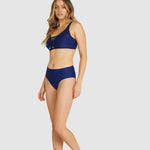 Side angle of navy blue Rococco bikini top featuring lace-up detail and wide straps.