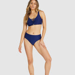 Model standing front-on in Baku Rococco Admiral bikini set, highlighting lace-up detail and structure.