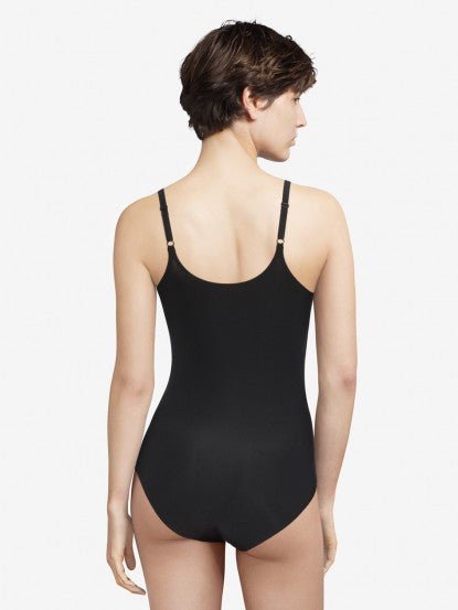 Back view of the Soft Stretch Bodysuit Black on model, from The Foundation, highlighting adjustable straps and seamless design for everyday comfort.