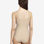 Back view of Soft Stretch Bodysuit Nude on model, from The Foundation, highlighting seamless design and adjustable straps for all-day comfort.
