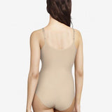 Back view of Soft Stretch Bodysuit Nude on model, from The Foundation, highlighting seamless design and adjustable straps for all-day comfort.