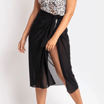 Model wearing the Cosmopolitan Classic Mesh Sarong Black by JANTZEN, available at The Foundation, styled over swimwear for a chic summer look.