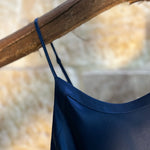 Close-up of Kelly Silk Chemise in navy, featuring delicate adjustable straps and smooth silk neckline binding.
