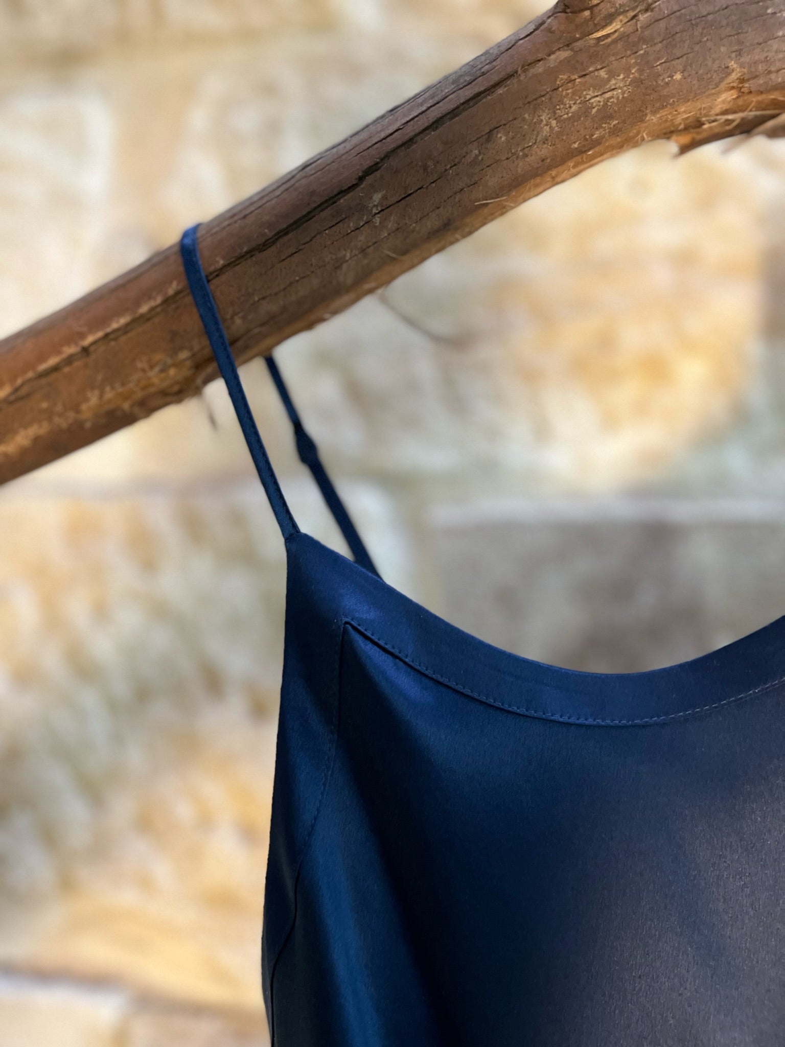 Close-up of Kelly Silk Chemise in navy, featuring delicate adjustable straps and smooth silk neckline binding.