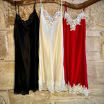 Kathryn Silk Chemise shown in rouge, black, and ivory colours hanging side by side.