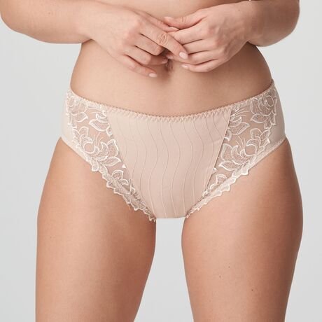 Model in PrimaDonna Deauville Full Brief in Café Latte from The Foundation, featuring high-waisted fit and decorative embroidery on the hips. front view