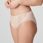 Model in PrimaDonna Deauville Full Brief in Café Latte from The Foundation, featuring high-waisted fit and decorative embroidery on the hips. side view