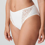Model wearing PrimaDonna Deauville Full Brief in Natural from The Foundation, with high waist coverage and floral embroidery at the hips. side view