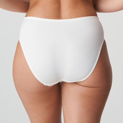 Model wearing PrimaDonna Deauville Full Brief in Natural from The Foundation, with high waist coverage and floral embroidery at the hips. back view