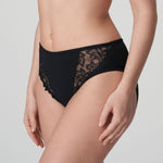 Model wearing PrimaDonna Deauville Full Brief in Black from The Foundation, with high waist fit and floral lace embroidery at the hips. side view