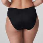 Model wearing PrimaDonna Deauville Full Brief in Black from The Foundation, with high waist fit and floral lace embroidery at the hips. back view
