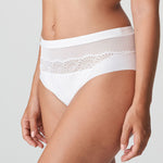 Side angle of Sophora Full Brief in White, showing sheer embroidered panels and smooth leg line.