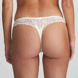 Model wearing Marie Jo Jane Thong Brief in Natural from The Foundation, with floral embroidery, sheer lace, and pearl-detailed bows at the back. BACK VIEW