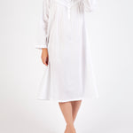 Model wearing Long Sleeve Embroidered White Nightie, featuring a v-neckline with embroidery and ruffled sleeves in soft cotton voile.