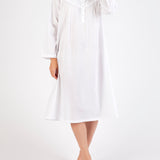 Model wearing Long Sleeve Embroidered White Nightie, featuring a v-neckline with embroidery and ruffled sleeves in soft cotton voile.