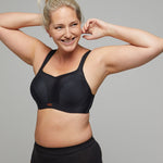 Panache Sports Bra in Black, worn by model with arms raised, maximum support with serious style.