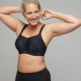 Panache Sports Bra in Black, worn by model with arms raised, maximum support with serious style.