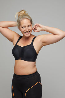 Panache Sports Bra in Black, worn by model with arms raised, maximum support with serious style.