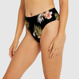 Side view of Baku black mid pant swim brief with full bottom coverage and tropical motif.