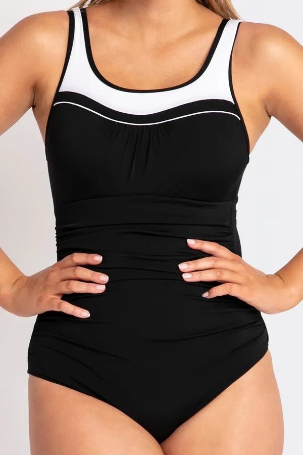Close-up of the swimsuit's neckline and chest area, highlighting shelf bra and mastectomy pocket placement.