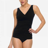Model wearing the POOLPROOF Sheath black one-piece swimsuit with crossover neckline and wide straps.
