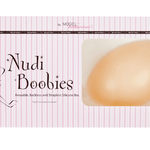 Packaging of Secret Weapons Nudie Boobies silicone stick-on bra in nude tone.