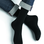 Model wearing Wool Cashmere Socks Mid Noir by Bleuforêt, available at The Foundation, showcasing soft, warm, black socks perfect for boots and winter wear.