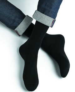 Model wearing Wool Cashmere Socks Mid Noir by Bleuforêt, available at The Foundation, showcasing soft, warm, black socks perfect for boots and winter wear.
