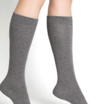Model wearing Wool Cashmere Socks Long Gris Flanelle by Bleuforêt, available at The Foundation, featuring soft, warm, knee-high grey socks for women.