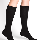 Model wearing Wool Cashmere Socks Long Noir by Bleuforêt, available at The Foundation, featuring black knee-high socks for warmth, comfort, and style.