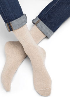 Model wearing Wool Cashmere Socks Mid Cordage by Bleuforêt, available at The Foundation, showing soft beige cashmere blend socks for warmth and comfort.